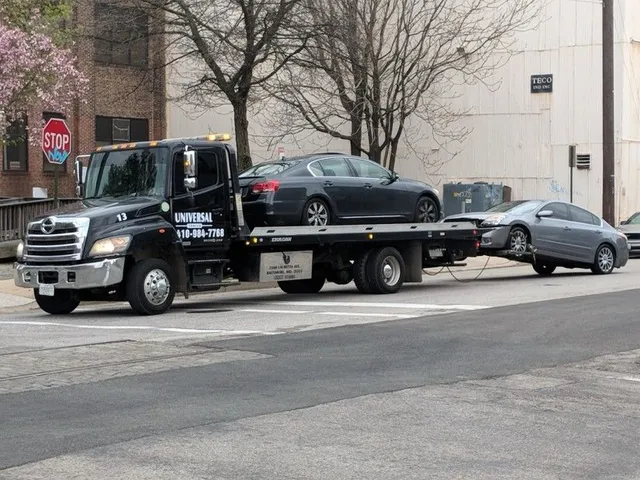 Universal Towing flatbed truck transporting multiple vehicles safely in Baltimore Maryland